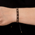 Beaded wristband bracelet, 'Rejoice in the Earth' - Brown and Black Beaded Wristband Bracelet from Guatemala