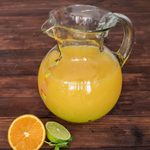 Recycled glass pitcher, 'Conga Line' - Hand Blown Recycled Glass Clear Green Colorful Dots Pitcher