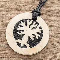Coconut shell and lava stone pendant necklace, 'Spread Your Branches' - Tree-Themed Coconut Shell and Lava Stone Pendant Necklace