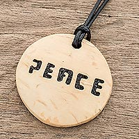 Coconut shell and lava stone pendant necklace, 'Have Peace' - Peace-Themed Coconut Shell and Lava Stone Pendant Necklace