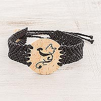 Coconut shell and lava stone macrame pendant bracelet, 'Abstract Phoenix' - Phoenix Coconut Shell and Lava Stone Pendant Bracelet