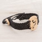 Coconut shell and lava stone macrame pendant bracelet, 'Abstract Phoenix' - Phoenix Coconut Shell and Lava Stone Pendant Bracelet
