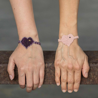 Beaded friendship bracelets, 'Two Hearts in Grape and Peach' (pair) - Purple and Peach Beaded Heart Friendship Bracelets (Pair)