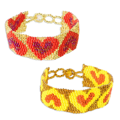 Beaded wristband friendship bracelets, 'Hearts in a Row' (pair) - Hand Crafted Glass Beaded Friendship Bracelets (Pair)