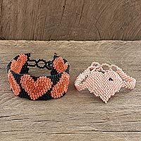 Beaded wristband friendship bracelets, 'Hearts in Melon and Peach' (pair) - Heart Motif Friendship Bracelets in Melon and Peach (Pair)