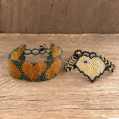 Beaded wristband friendship bracelets, 'Hearts in Gold' (pair) - Hand Crafted Beaded Heart Motif Friendship Bracelets (Pair)
