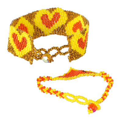 Beaded wristband friendship bracelets, 'Hearts in Orange' (pair) - Yellow and Orange Heart Beaded Friendship Bracelets (Pair)