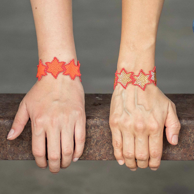 Beaded wristband friendship bracelets, 'Star Duo in Orange' (pair) - Beaded Star Shaped Friendship Bracelets in Orange (Pair)