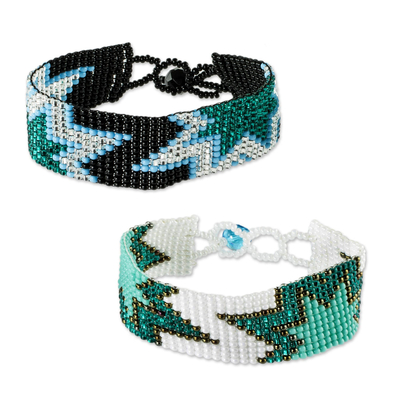 Beaded wristband friendship bracelets, 'Twin Stars in Teal' (pair) - Artisan Crafted Beaded Star Friendship Bracelets (Pair)