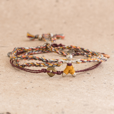 Braided cord bracelets, 'Multicolor Maize Man' (pair) - Braided Cord Bracelet with Corn Man Pendant from Guatemala