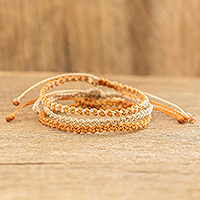 Macrame bracelets, 'Harmonious Song in Saffron' (set of 3) - Orange and Beige Macrame Bracelets (Set of 3)