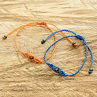 Beaded macrame bracelets, 'Art of Knots in Fire and Sea' (pair) - Handcrafted Orange and Blue Beaded Macrame Bracelets (Pair)