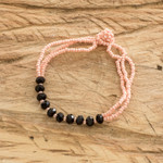 Glass and crystal beaded bracelet, 'Flamingo Hug' - Handmade Pink and Black Beaded Bracelet from Guatemala