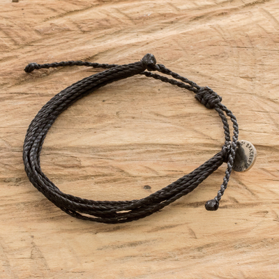 Handcrafted cord wristband bracelet, 'Charcoal' - Unisex Black Cord Wristband Bracelet with Strands and Charm