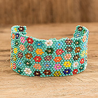 Glass beaded wristband bracelet, 'Cool Blossoming Harmony' - Handcrafted Floral Glass Beaded Wristband Bracelet in Green