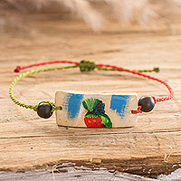 Onyx and coconut shell macrame beaded pendant bracelet, 'Chic Quetzal' - Onyx and Coconut Shell Macrame Beaded Bird Pendant Bracelet