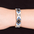 Leather-accented glass beaded cuff bracelet, 'Deity Diamonds' - Ivory and Blue Glass Beaded Cuff Bracelet with Leather