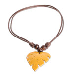 Wood and calabash gourd pendant necklace, 'Jungle Yellow' - Leafy Yellow Calabash Gourd Pendant Necklace with Wood Beads