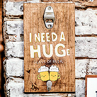 Wood wall-mounted bottle opener, 'I Need a Hug' - Hand-Painted Wood Wall-Mounted Bottle Opener from Costa Rica