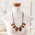 Coconut shell and ceramic waterfall necklace, 'Organic Splendor' - Coconut Shell & Ceramic Waterfall Necklace with Cotton Cord