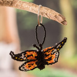 Glass beaded keychain, 'Fluttering Hopes' - Handcrafted Black and Orange Glass Beaded Butterfly Keychain