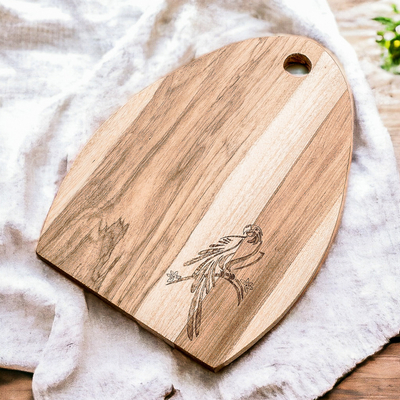 Wood cutting board, 'Macaw's Treats' - Semi-Oval Laurel Wood Cutting Board with Macaw Engraving