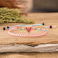 Glass beaded friendship bracelets, 'Romantic Bond' (set of 2) - Set of 2 Handcrafted Pink and Turquoise Heart Bracelets