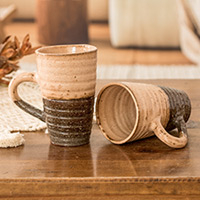 Ceramic mugs, 'Tender Flavor' (pair) - Handcrafted Ceramic Mugs in Ivory and Dark Brown (Pair)