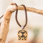 Coconut shell and lava stone pendant necklace, 'Spiritual Liberation' - Coconut Shell and Lava Stone Tijax Sign Pendant Necklace