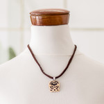 Coconut shell and lava stone pendant necklace, 'Dream Seeker' - Coconut Shell and Lava Stone K'at Sign Pendant Necklace