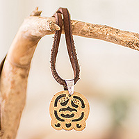 Coconut shell and lava stone pendant necklace, 'Harmony and Peace' - Coconut Shell and Lava Stone Ak'ab'al Sign Pendant Necklace
