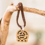Coconut shell and lava stone pendant necklace, 'Harmony and Peace' - Coconut Shell and Lava Stone Ak'ab'al Sign Pendant Necklace