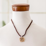 Coconut shell and lava stone pendant necklace, 'Harmony and Peace' - Coconut Shell and Lava Stone Ak'ab'al Sign Pendant Necklace