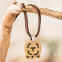Coconut shell and lava stone pendant necklace, 'Strength and Renewal' - Coconut Shell and Lava Stone Iq' Sign Pendant Necklace