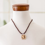 Coconut shell and lava stone pendant necklace, 'Spiritual Union' - Coconut Shell and Lava Stone Kawoq Sign Pendant Necklace