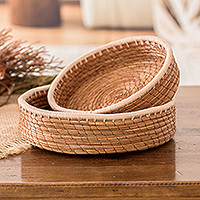 Pine needle baskets, 'Ivory Lands' (set of 2) - Set of 2 Woven Spiral Pine Needle Baskets with Ivory Trim