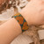Beaded wristband bracelet, 'Golden Empress of Love' - Handcrafted Adjustable Beaded Bracelet with Heart Patterns