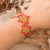 Beaded wristband bracelet, 'Honey Starlight' - Red and Golden-Hued Handmade Beaded Bracelet with Star Motif