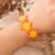 Beaded wristband bracelet, 'Yellow Starlight' - Star-Themed Beaded Wristband Bracelet in Yellow and Orange