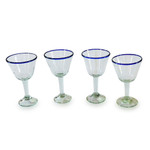 Handblown recycled glass wine glasses, 'Waves of Glee' (set of 4) - Set of 4 Eco-Friendly Handblown Wine Glasses with Blue Rim