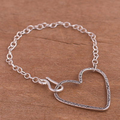 Sterling silver pendant bracelet, 'Tugged Heart' - Handcrafted Sterling Silver Textured Heart Pendant Bracelet
