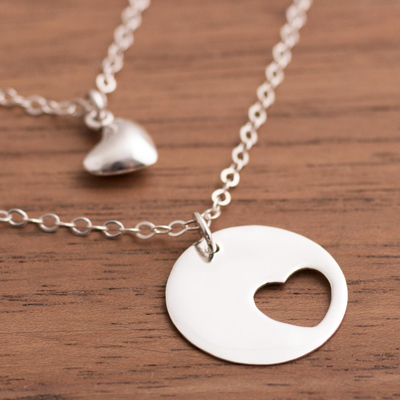 Sterling silver pendant necklace, 'Complementary Hearts' - Heart-Shaped Sterling Silver Pendant Necklace from Peru