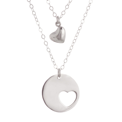 Sterling silver pendant necklace, 'Complementary Hearts' - Heart-Shaped Sterling Silver Pendant Necklace from Peru