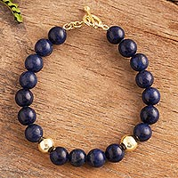Gold accent lapis lazuli beaded bracelet, 'Golden Sea' - Gold Accent Lapis Lazuli Beaded Bracelet from Peru