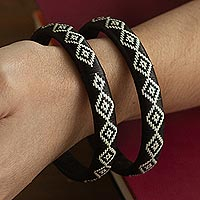 Natural fiber bangle bracelets, 'Black Island Magic' (pair) - Brown and Ivory Woven Bangles (Pair)