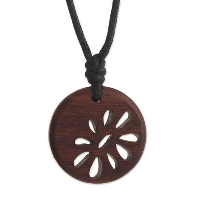 Wood pendant necklace, 'Balsam Flower' - Wooden Disk with Abstract Flower Design on Cotton Cord