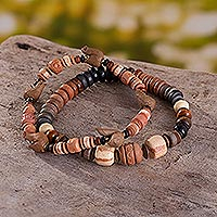 Ceramic beaded stretch bracelets, 'Bird-Watching' (pair) - Bracelets with Ceramic Beads and Small Bird Figures (Pair)