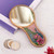 Reverse-painted glass hand mirror, 'Primaveral Fields' - Baroque-Themed Floral Reverse-Painted Glass Wood Hand Mirror (image 2) thumbail
