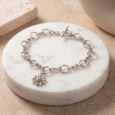 Sterling silver charm bracelet, 'Blooming Aurelia' - Spring-Themed Sterling Silver Bracelet with Floral Charm