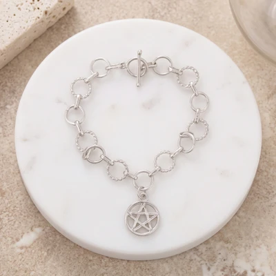 Sterling silver charm bracelet, 'Divine Symmetry' - Artisan-Made Sterling Silver Link Bracelet with Star Charm